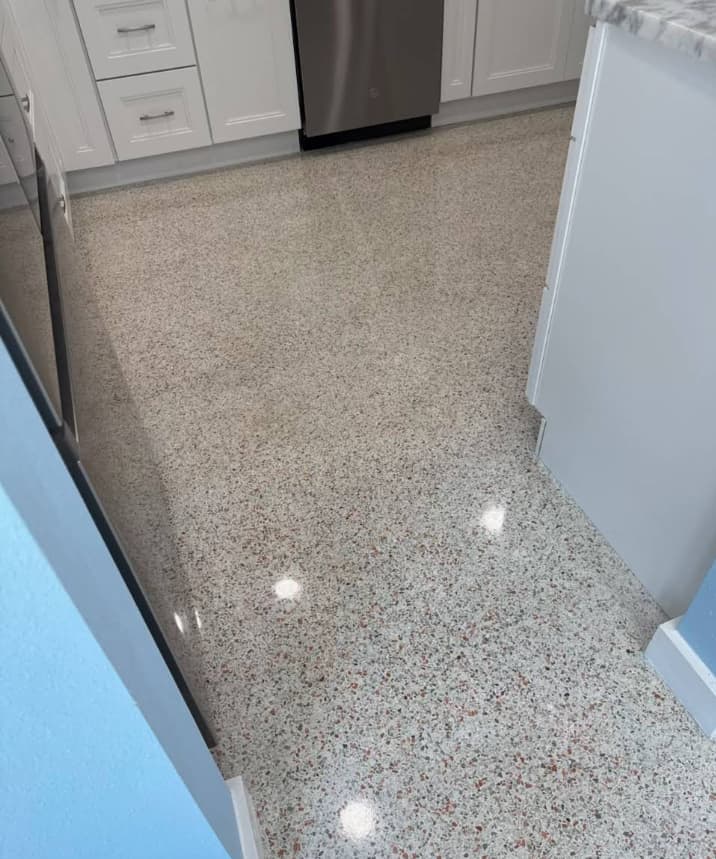 Completed terrazzo floor restoration with speckled aggregate in a Tampa Bay kitchen
