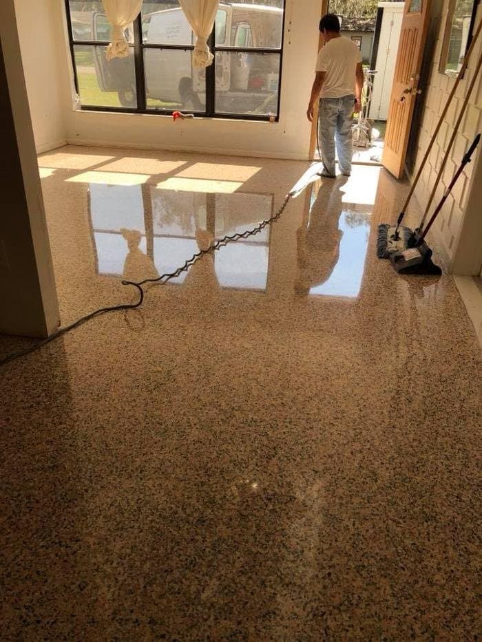 Restored terrazzo living room floor with a high-gloss polish and warm tan and pink aggregate in Tampa Bay Area
